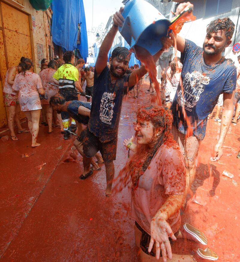 A reveller plays with tomato pulp. Reuters