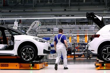 An employee of German car maker Volkswagen works on an assembly line. The company's Autoeuropa plant in Portugal will halt production from March 22 to 28 due to shortage of semiconductors.  AFP 