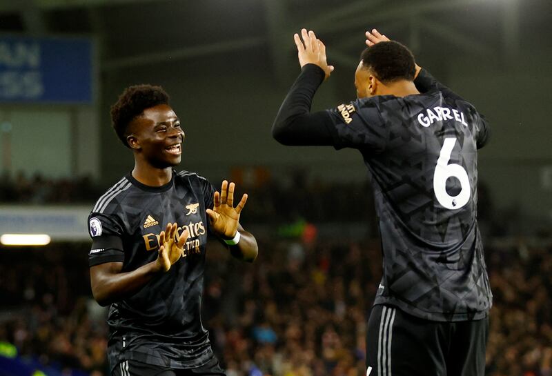 Arsenal's Bukayo Saka celebrates scoring with Gabriel. Reuters