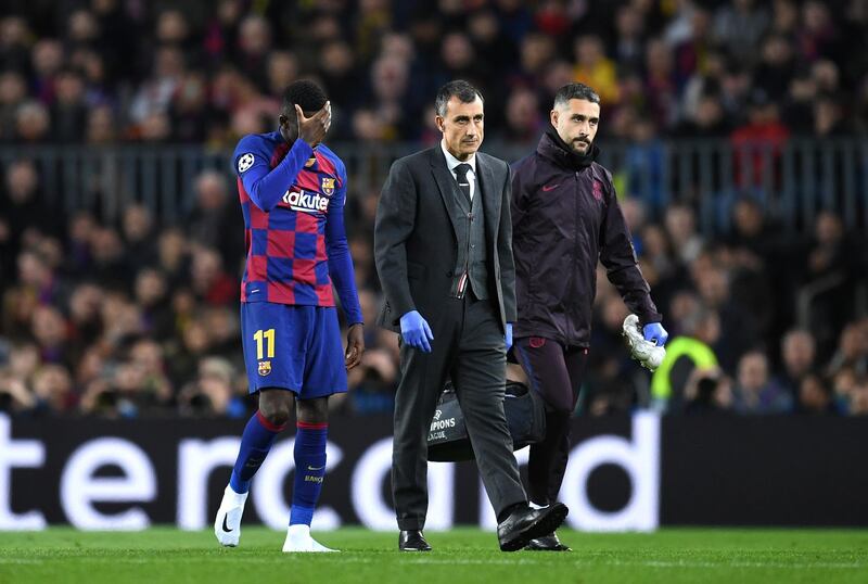 Barcelona's Ousmane Dembele limps off in the first half after picking up an injury. Getty