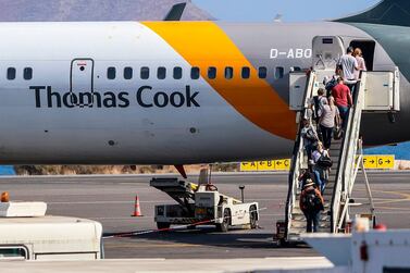 Tourists in Greece board a Thomas Cook plane. The British government has begun its biggest peacetime repatriation after the collapse of the tour operator left 600,000 holidaymakers stranded. AFP.