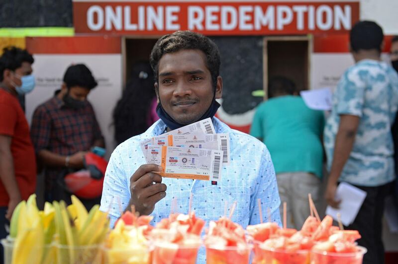 A fan shows his ticket for the second Test which begins on Saturday. AFP