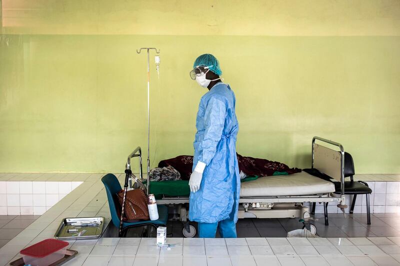 A Health worker tends to a patient inside a Covid-19 coronavirus ward that hosts suspected cases in Pikine Hospital in Dakar. As coronavirus cases slowly increase in Senegal, hospitals are preparing to test suspected cases whilst safely treating other patients. AFP