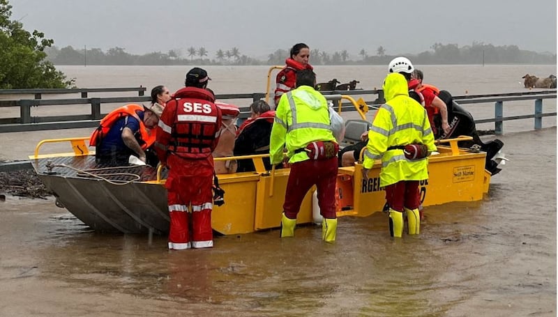 Rescuers evacuate people from a flooded area in northern Queensland after heavy rain caused by cyclone Jasper. Reuters