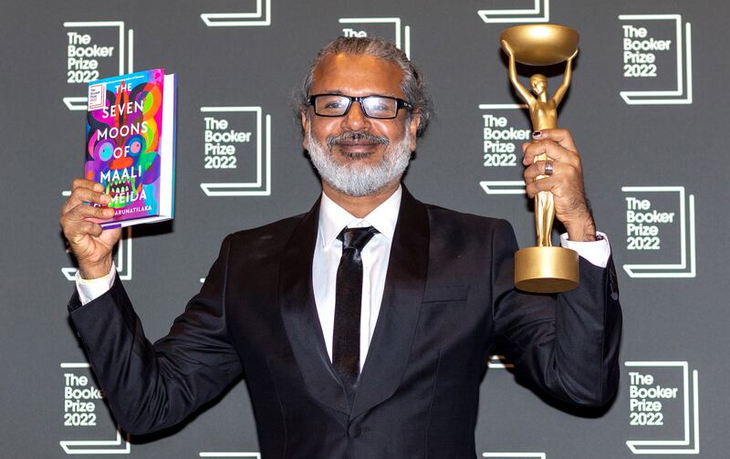 Shehan Karunatilaka with his book 'The Seven Moons of Maali Almeida' after being announced the winner of last year's Booker Prize, in London. EPA
