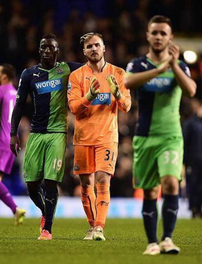 Goalkeeper Jak Alnwick, centre, of Newcastle United is consoled by Massadio Haidara of Newcastle United after their League Cup quarter-final match loss to Tottenham Hotspur at White Hart Lane on December 17, 2014 in London, England. (Photo by Jamie McDonald/Getty Images)