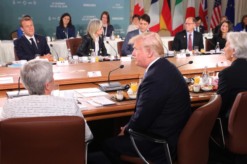 French President Emmanuel Macron, left (L rear), US President Donald Trump (C front), Canadian Prime Minister Justin Trudeau (C rear) and International Monetary Fund Managing Director Christine Lagarde (R front) attend the Gender Equality Advisory Council Breakfast during the G7 Summit in La Malbaie, Quebec, Canada. POOL FOR EPA