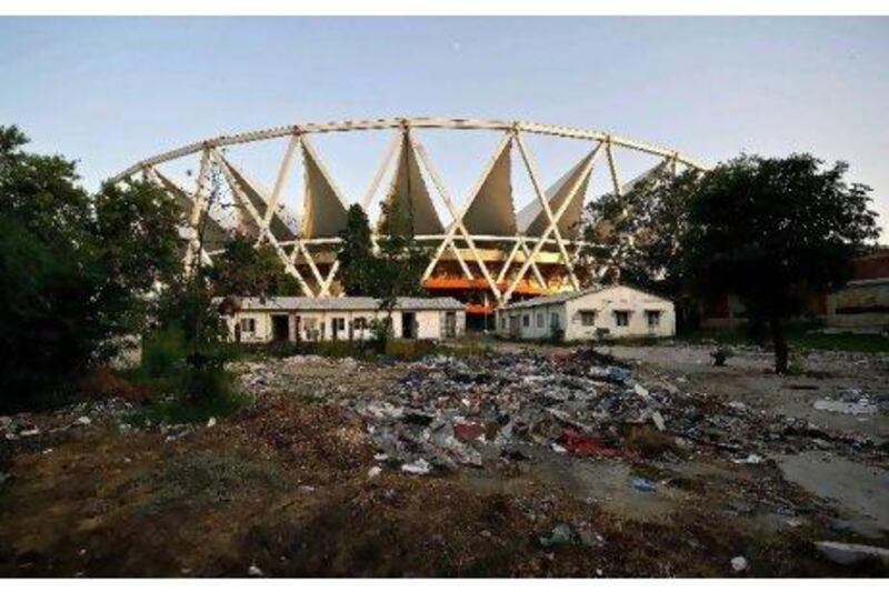 Garbage and junk strewn on the grounds of JawaharLal Nehru Stadium in New Delhi. One year after the Commonwealth Games in New Delhi, its organisers languish in jail on corruption charges and foreign companies are fighting legal battles over millions of dollars in unpaid bills. MANAN VATSYAYANA / AFP PHOTO