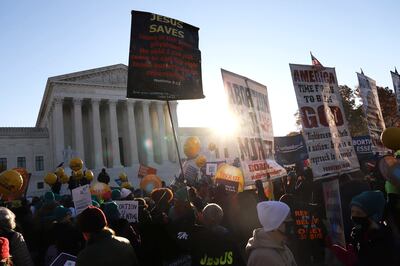Protesters demonstrate in front of the US Supreme Court as it hears arguments in the case. AP