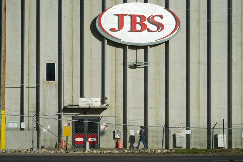 FILE - In this Oct. 12, 2020 file photo, a worker heads into the JBS meatpacking plant in Greeley, Colo. The worldâ€™s largest meat processing company says it paid the equivalent of $11 million to hackers who broke into its computer system late last month. Brazil-based JBS SA said on May 31 that it was the victim of a ransomware attack, but Wednesday, June 9, 2021 was the first time the companyâ€™s U.S. division confirmed that it had paid the ransom. (AP Photo/David Zalubowski, File)