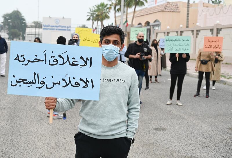 A business owner in Kuwait City with a placard reading 'Closure ends in bankruptcy and jail'. The Kuwaiti government is being urged to rethink its closure of salons and health clubs to contain the spread of the coronavirus. EPA