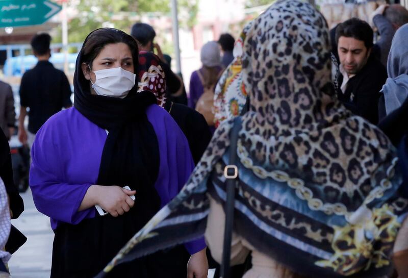 An Iranian woman wearing face mask goes shopping in Tehran, Iran. EPA