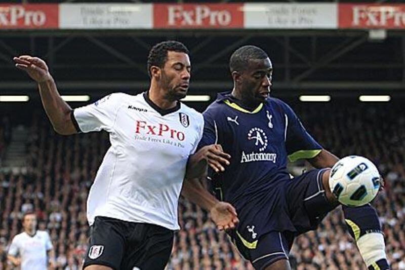 Tottenham’s Sebastien Bassong, right, outmuscles Fulham’s Moussa Dembele to the ball.