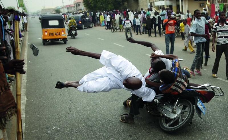 Supporters of winning presidential candidate Muhammadu Buhari hits another supporter with a motorbike during celebrations in Kano, Nigeria in March. Goran Tomasevic / Reuters / March 31, 2015