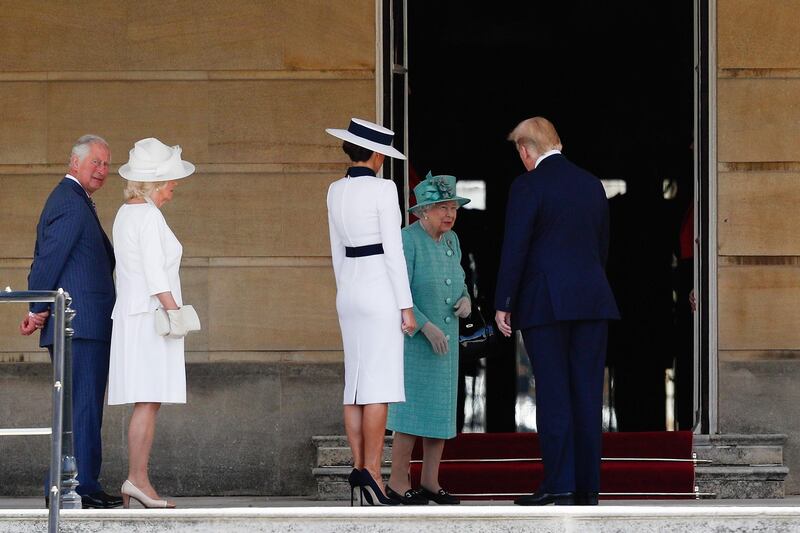 US President Donald Trump (R) and US First Lady Melania Trump (C) are greeted by Britain's Queen Elizabeth II (2R) after being met by Britain's Prince Charles, Prince of Wales (L) and Britain's Camilla, Duchess of Cornwall (2L) during a welcome ceremony at Buckingham Palace in central London on June 3, 2019, on the first day of the US president and First Lady's three-day State Visit to the UK. AFP