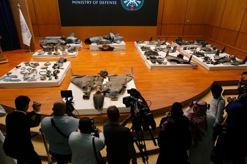 Journalists film what Saudi military spokesman Col. Turki al-Malki said was evidence of Iranian weaponry used in the attack targeted Saudi Aramco's facilities, during a press conference in Riyadh, Saudi Arabia, Wednesday, September 18, 2019.  AP Photo