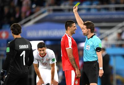 KALININGRAD, RUSSIA - JUNE 22:  Aleksandar Mitrovic of Serbia is shown a yellow card by referee Felix Brych during the 2018 FIFA World Cup Russia group E match between Serbia and Switzerland at Kaliningrad Stadium on June 22, 2018 in Kaliningrad, Russia.  (Photo by Matthias Hangst/Getty Images)