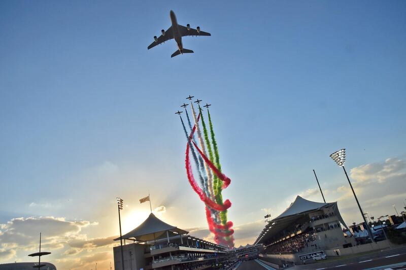 Aermacchi MB-339 jets from UAE's Al-Fursan display team perform with an Etihad Airways' Airbus A380 before the start of the Abu Dhabi Formula One Grand Prix at the Yas Marina circuit on November 26, 2017. (Photo by GIUSEPPE CACACE / AFP)