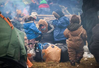 Migrants from the Middle East and elsewhere camp at the checkpoint Kuznitsa at the Belarus-Poland border near Grodno, Belarus, in November 2021.  Some of the migrants have children with them at the border in their desperate bid to reach the EU.  Most are fleeing conflict, poverty and instability. AP