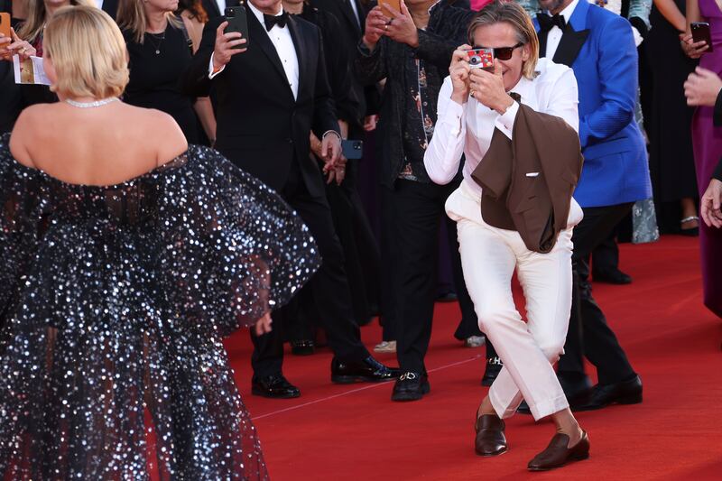 Chris Pine enjoying the moment by taking a photo of Florence Pugh on the red carpet. AP Photo