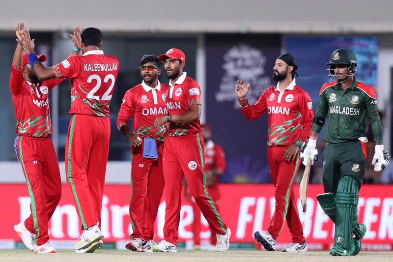 Oman's Kaleemullah celebrates with teammates after the dismissal of Bangladesh's Mahedi Hasan. AFP