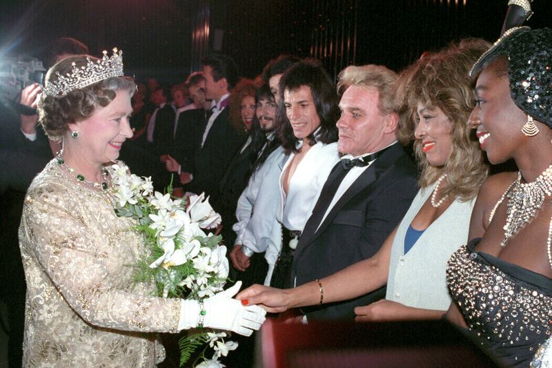 Turner meets Britain's Queen Elizabeth II in 1989 at the London Palladium. PA 