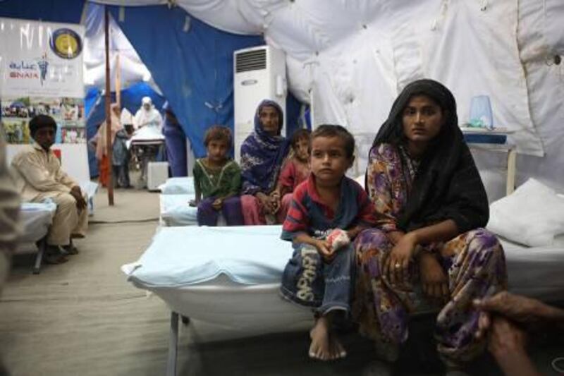 Pakistan - Karachi - October 5th, 2010:  Children wait with their mothers to receive medical care at a UAE medical clinic in Thatta, Pakistan.  (Galen Clarke/The National)