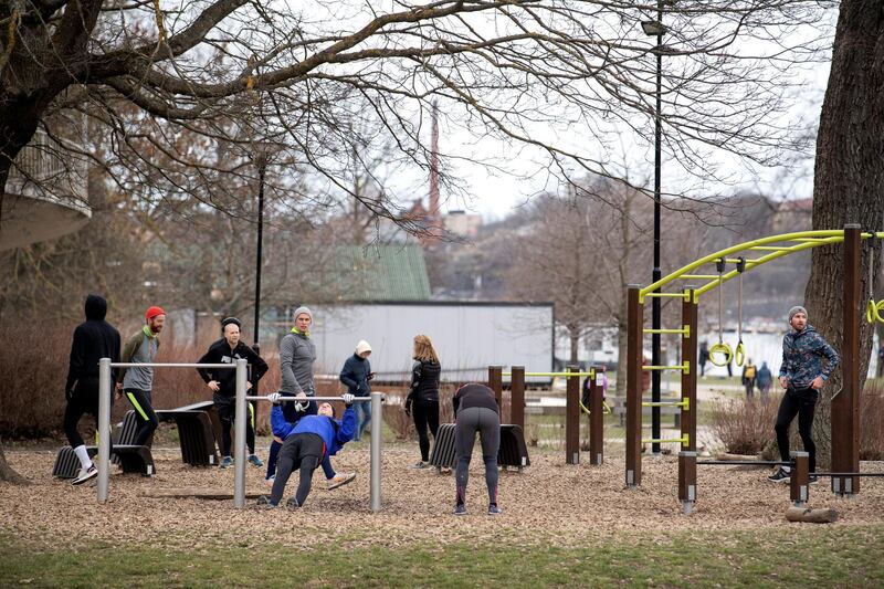 People exercise at an outdoor gym in a park in central Stockholm, Sweden, on April 1, 2020. Reuters