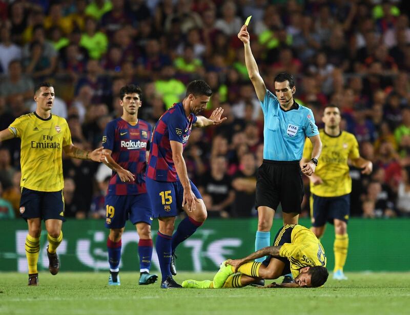 Clement Lenglet of Barcelona is shown a yellow card by referee Juan Martinez Munuera after a challenge on Dani Ceballos. Getty