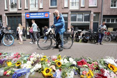 People leave flowers at the spot Dutch crime reporter de Vries was shot in Amsterdam. AP