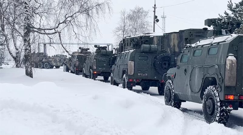Russian military vehicles wait to be loaded on to military aircraft at an airfield outside Moscow, to fly to Kazakhstan. They are part of an alliance of former Soviet states being sent to control the uprising. AP