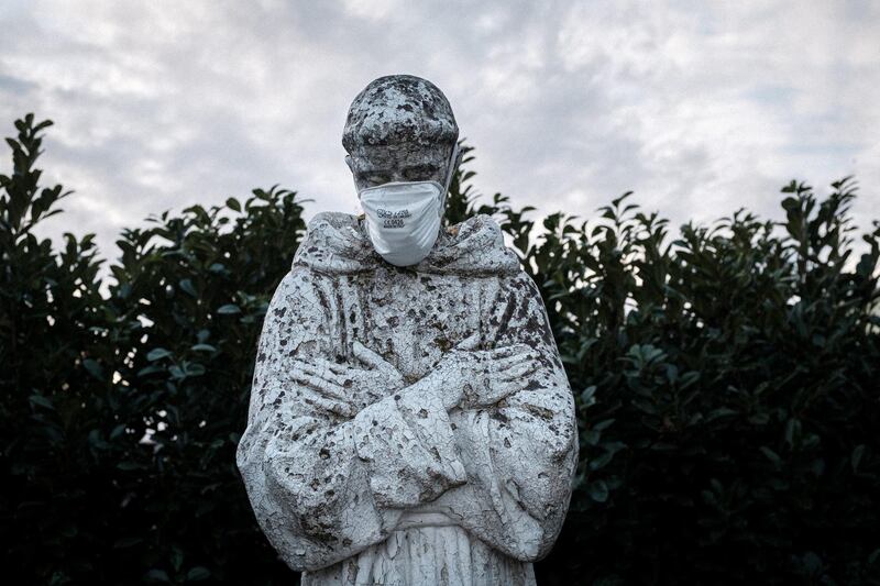 A protective mask has been put on the face of a statue of Italy's patron saint, St. Francis, in San Fiorano, one of the towns on lockdown due to a coronavirus outbreak, in this picture taken by schoolteacher Marzio Toniolo in San Fiorano, Italy. Reuters