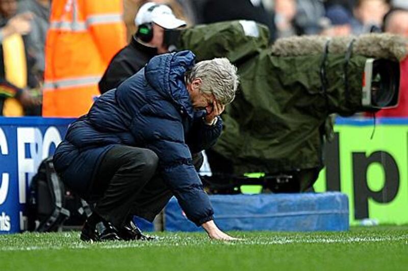 Arsene Wenger slumps to the ground after Birmingham scored their late equaliser.