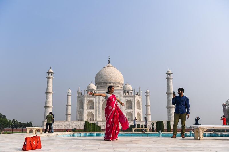 Tourists visit the Taj Mahal in Agra. The Taj Mahal reopened to visitors on September 21. AFP