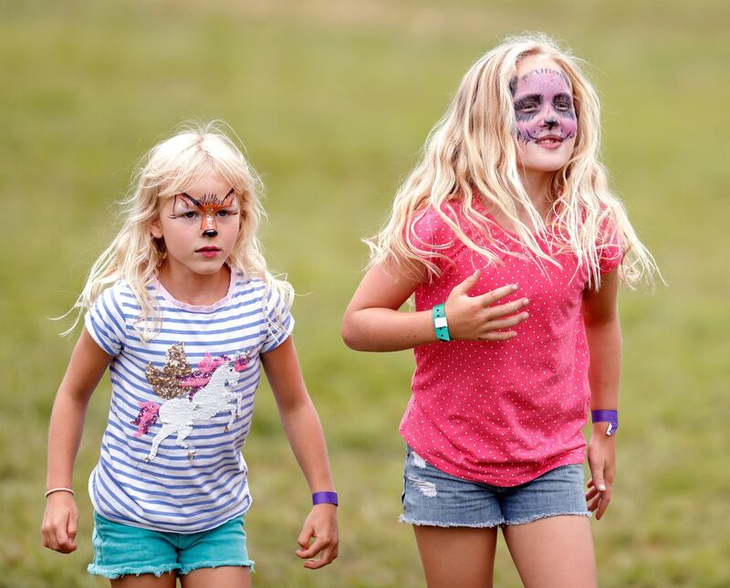 STROUD, UNITED KINGDOM - AUGUST 04: (EMBARGOED FOR PUBLICATION IN UK NEWSPAPERS UNTIL 24 HOURS AFTER CREATE DATE AND TIME) Isla Phillips and Savannah Phillips, seen wearing animal design face paint, attend day 3 of the 2019 Festival of British Eventing at Gatcombe Park on August 4, 2019 in Stroud, England. (Photo by Max Mumby/Indigo/Getty Images)