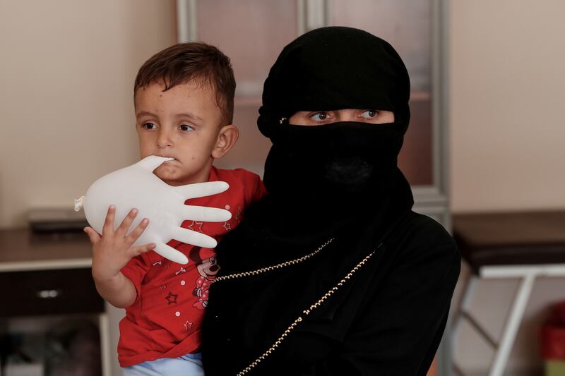Afghan migrant Benevse and her son Rehimullah, 2, wait for a medical check in Van after being picked up by security forces for entering illegally. Reuters