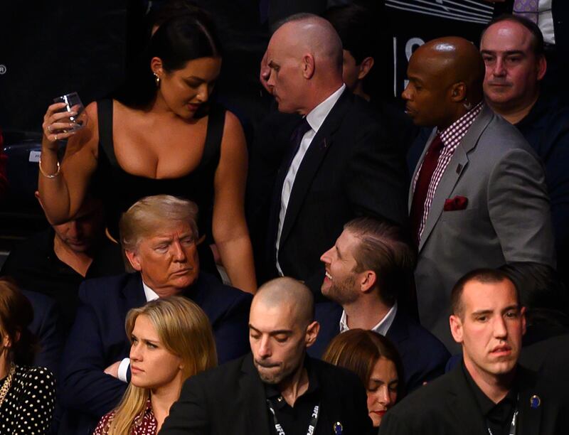 Eric Trump, right, sits next to his father US President Donald Trump to watch UFC 244. AFP