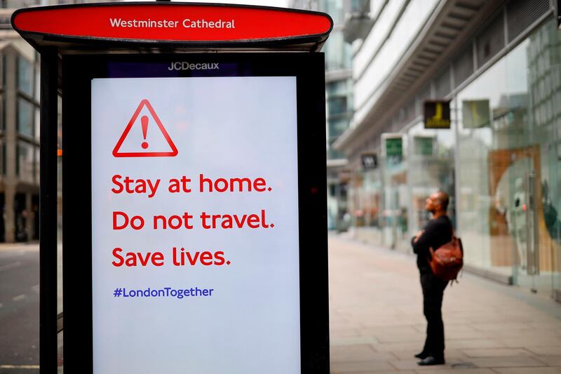 A sign encouraging people to stay at home is displayed on a busstop along Victoria Street, central London. AFP