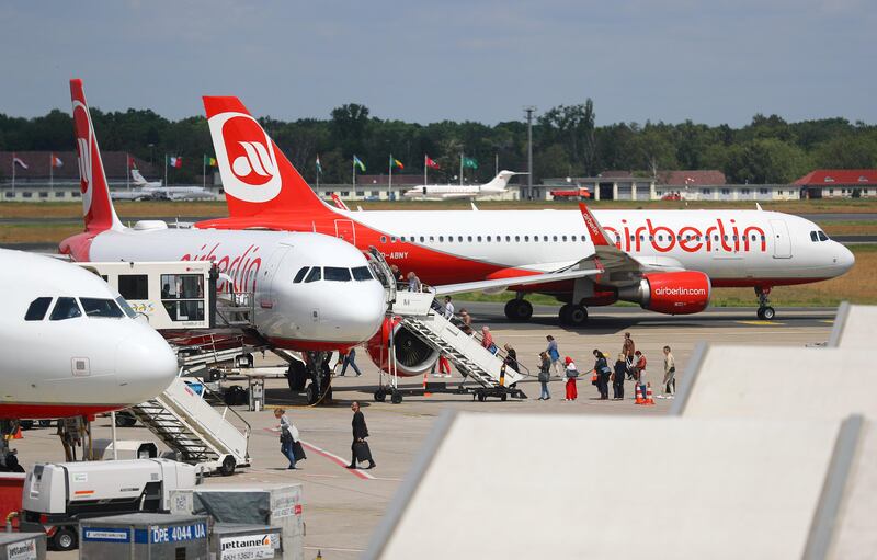 FILE PHOTO: Passengers board an Air Berlin aircraft at Tegel airport in Berlin, Germany, June 14, 2017. REUTERS/Hannibal Hanschke/File Photo