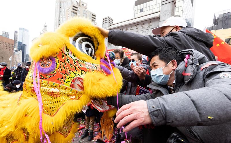 Dancers in costume perform a Chinese Lion Dance, a traditional dance intended to bring good luck and fortune, as people launch confetti and make good luck donations in red envelopes as part of an observation of the Chinese Lunar New Year in the Chinatown neighborhood of New York. EPA