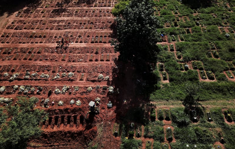Aerial view of an excavator opening graves at Vila Nova Cachoeirinha cemetery in Sao Paulo, Brazil.