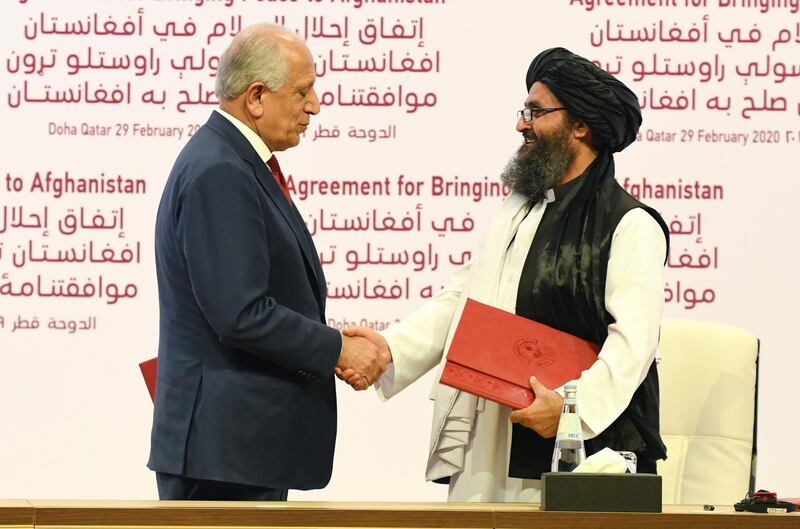 epa08259475 US Special Representative for Afghanistan Reconciliation Zalmay Khalilzad (L) and Taliban co-founder Mullah Abdul Ghani Baradar shake hands during the signing ceremony of the US-Taliban peace agreement in Doha, Qatar, 29 February 2020. The United States and the Taliban on 29 February penned a historic Agreement to Bringing Peace to Afghanistan which paves the way for the withdrawal of US troops and intra-Afghan negotiations.  EPA/STRINGER