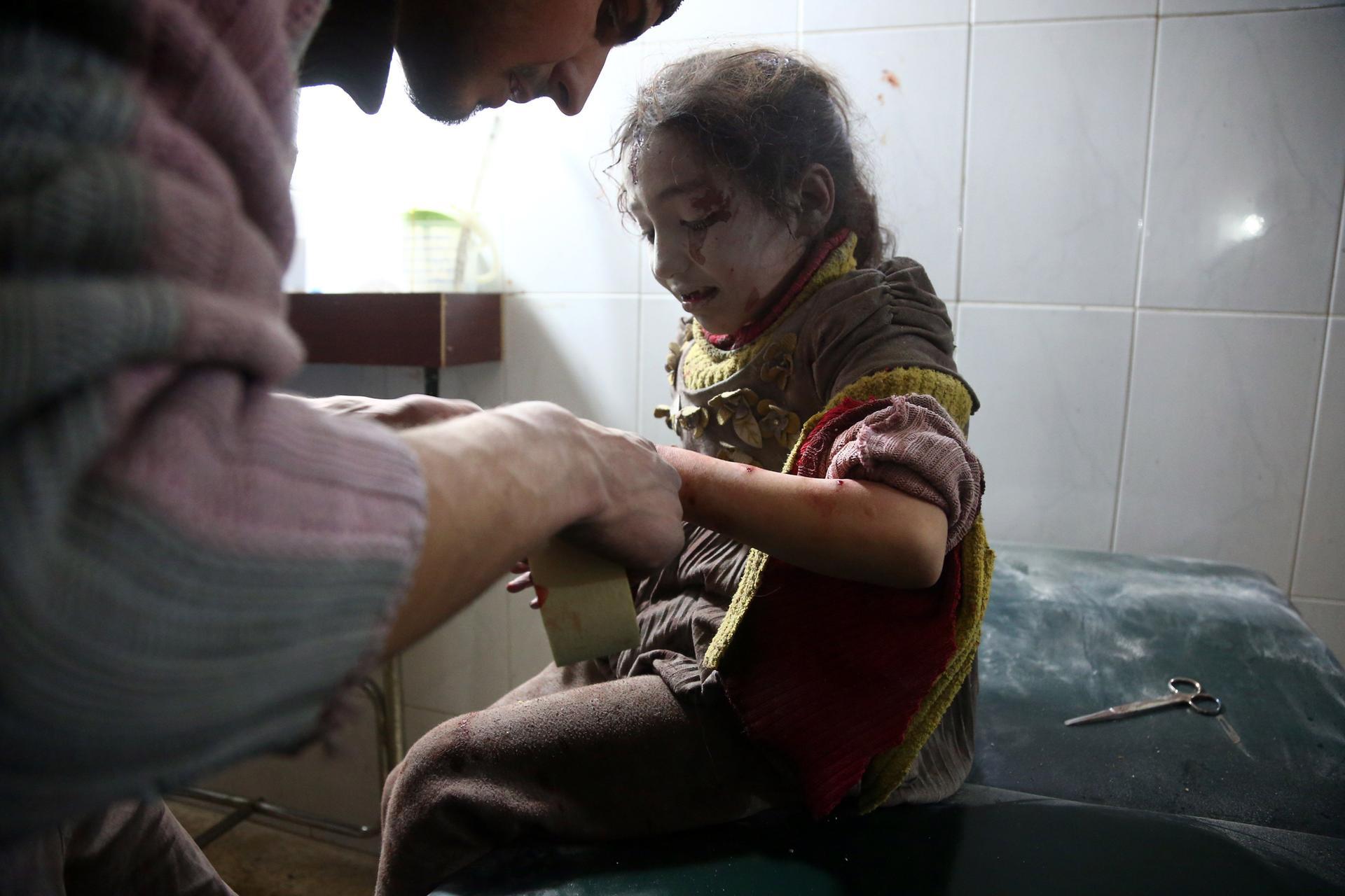 A child receives treatment at a makeshift hospital following Syrian air force strikes in the town of Hamouria in the Eastern Ghouta region on February 8, 2018. Abdulmonam Eassa / AFP