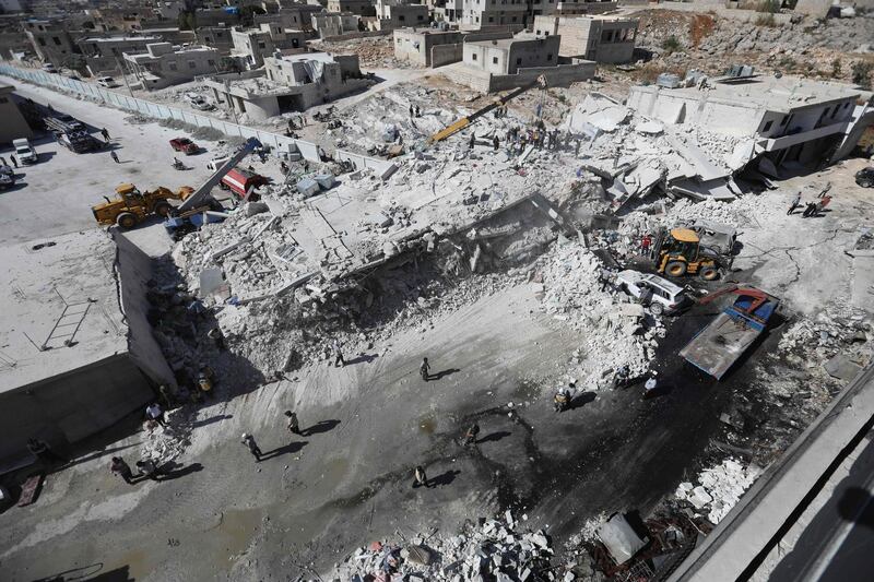 TOPSHOT - Destroyed buildings are seen on August 12, 2018 following an explosion at an arms depot in a residential area in Syria's northern Idlib province city of Sarmada in which 12 people were reportedly killed. (Photo by OMAR HAJ KADOUR / AFP)