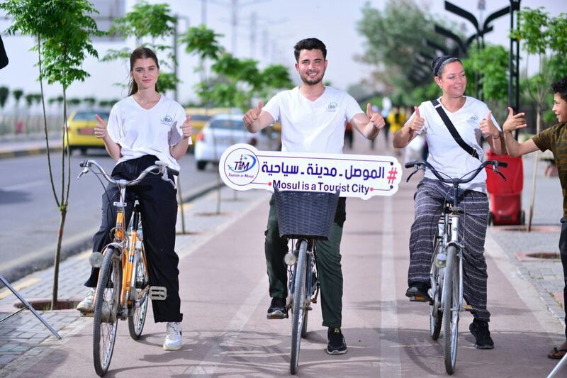 Harith Faris takes foreign tourists on a bike tour around Mosul. Photo: Harith Faris
