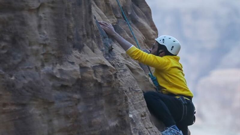 Scale ancient rock faces in AlUla. Photo: Visit AlUla