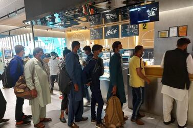 Pakistani passengers queue for free meals after being told they could not leave Dubai International Airport. Consulate General of Pakistan in Dubai 