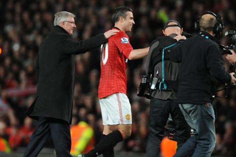 Sir Alex Ferguson and Robin Van Persie celebrate Manchester United's 20th championship win.