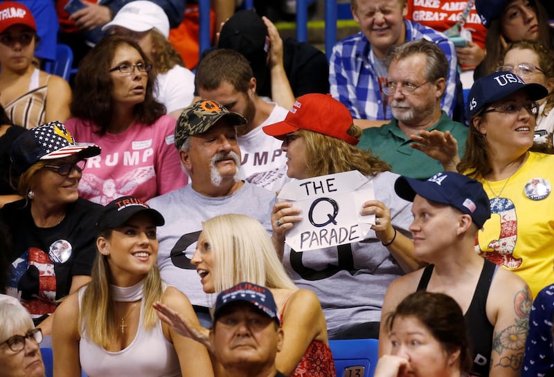 A supporter holds a QAnon sign as US President Donald Trump addresses a campaign rally at Mohegan Sun Arena in Wilkes-Barre, Pennsylvania, August 2, 2018. A 2019 bulletin from the FBI warned that conspiracy theory-driven extremists are a domestic terrorism threat. Reuters