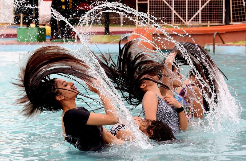 Indian girls beat the heat in Kanha Fun City Water Park in Bhopal, India.  EPA